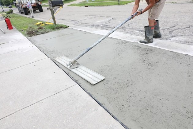 Smooth, restored concrete driveway after professional crack repair