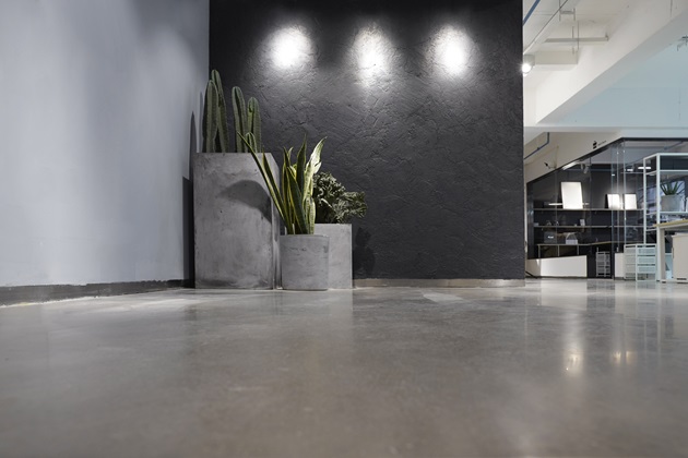 Smooth grey polished concrete kitchen countertop and floor